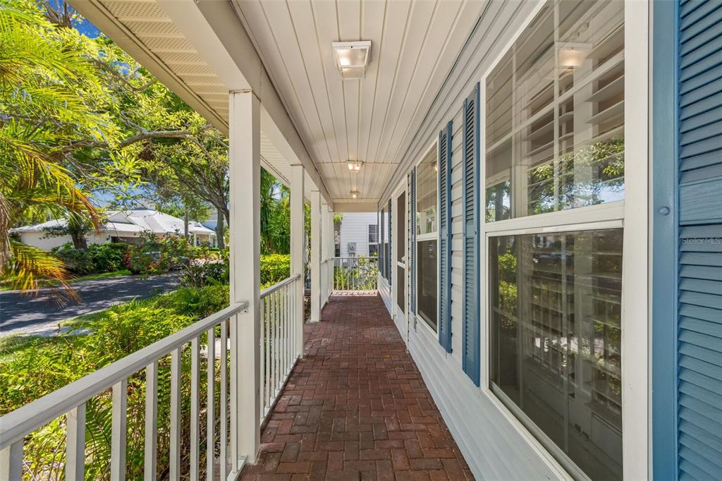 A dining room with a round wooden table, white chairs, and light blue walls — 6414 23RD AVE DR W, BRADENTON, FL