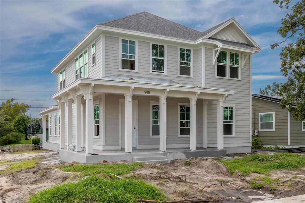 A two-story light gray house with a front porch and white trim under construction — 995 48TH AVENUE N, ST PETERSBURG, FL