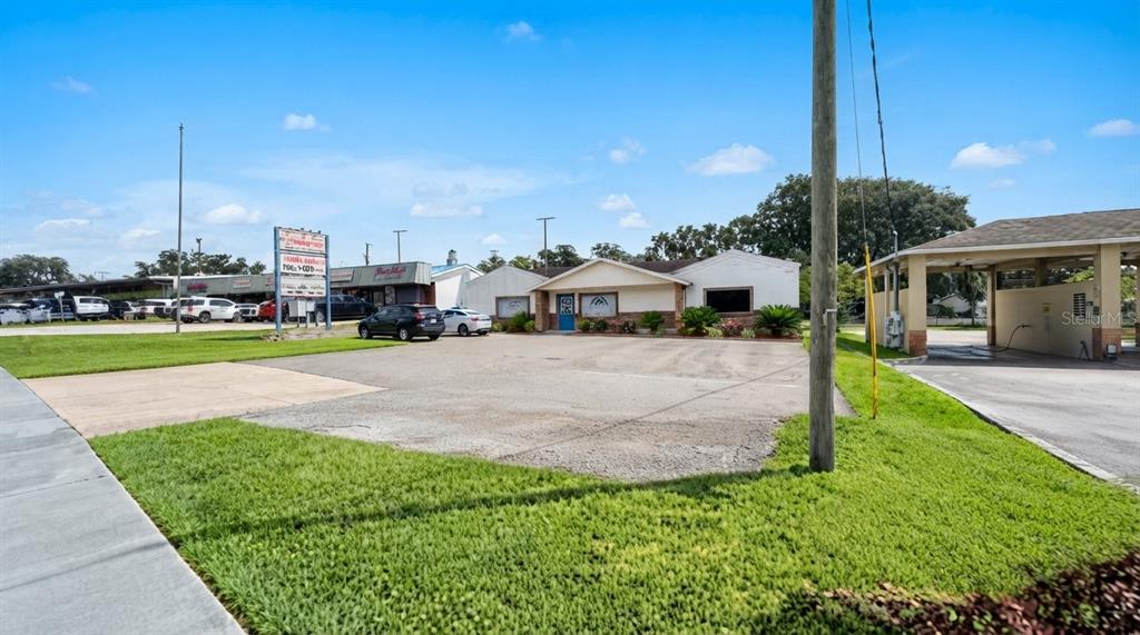 A single-story commercial building with a brick facade and a parking lot in front — 223 N COMMONWEALTH AVENUE SW, POLK CITY, FL