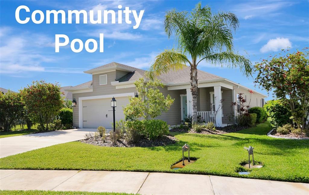 A single-story house with a tan exterior, a two-car garage, and a palm tree — 4815 DEEP CREEK TERRACE, PARRISH, FL