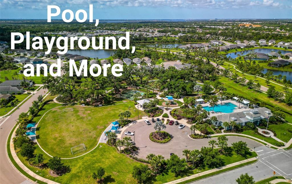 An aerial view shows a community park with a swimming pool, playground, and sports field — 4815 DEEP CREEK TERRACE, PARRISH, FL