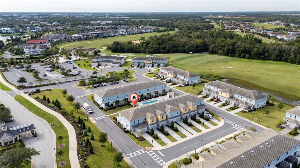 An aerial view shows a residential complex with townhouses, a swimming pool, and a golf course — 7900 DRAW STREET, REUNION, FL