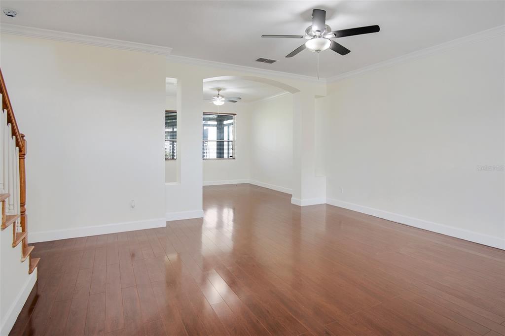 A two-story gray house features a two-car garage, a covered entryway, and a front lawn — 12661 ENCLAVE DRIVE, ORLANDO, FL