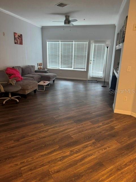 A living room features wood-look flooring, a gray sectional sofa, and a ceiling fan — 3615 CONROY ROAD UNIT 627, ORLANDO, FL