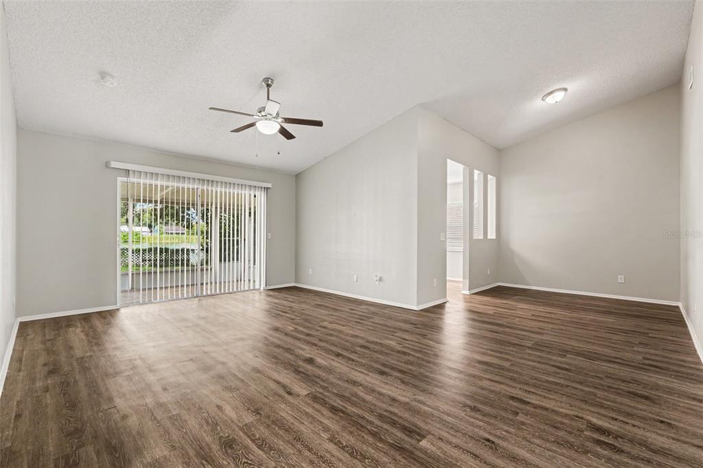A kitchen with white cabinets, stainless steel appliances, and black granite countertops — 8304 NATCHEZ STREET, TAMPA, FL