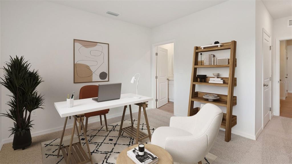A home office features a white desk, a wooden bookshelf, and a cream-colored armchair — 5416 SW 55TH TERRACE, GAINESVILLE, FL