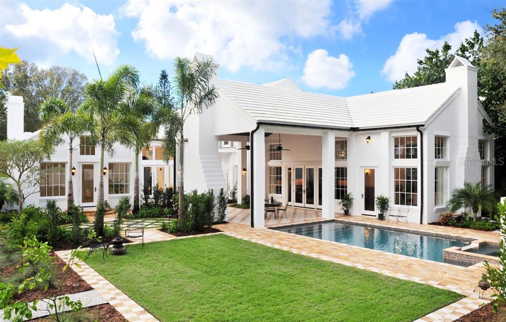 A white house with a tiled roof, a covered patio, and a swimming pool in back — 1740 S ORANGE AVENUE, SARASOTA, FL