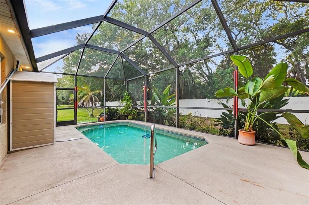 A dining area with tile flooring, a modern pendant light, and a window facing outside — 7610 TANGLE BROOK BOULEVARD, GIBSONTON, FL