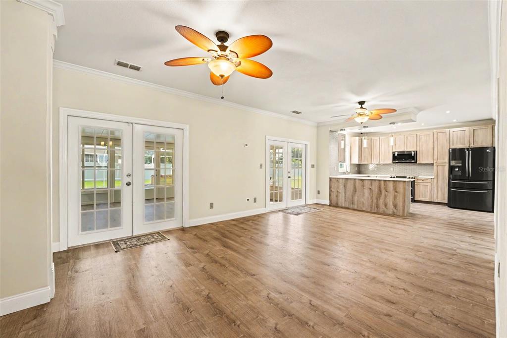 A dining room with two-tone green walls, a built-in wine rack, and wood-look flooring — 100 SYLVANA COURT, AUBURNDALE, FL