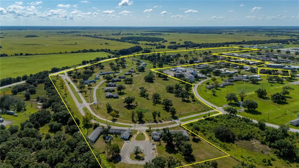 An aerial view shows a large rural property with multiple buildings and paved access roads — 6000 SE HWY 31, ARCADIA, FL