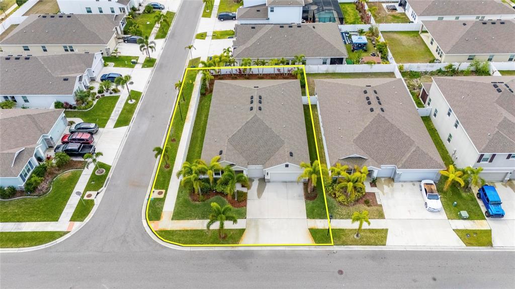 An aerial view shows a residential duplex with a yellow outline on its corner lot — 446 6TH AVENUE NW, RUSKIN, FL