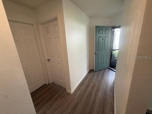 A kitchen features wood-grain cabinets, stainless steel appliances, and light-colored wood-look flooring — 2131 RIDGE ROAD S UNIT 74, LARGO, FL