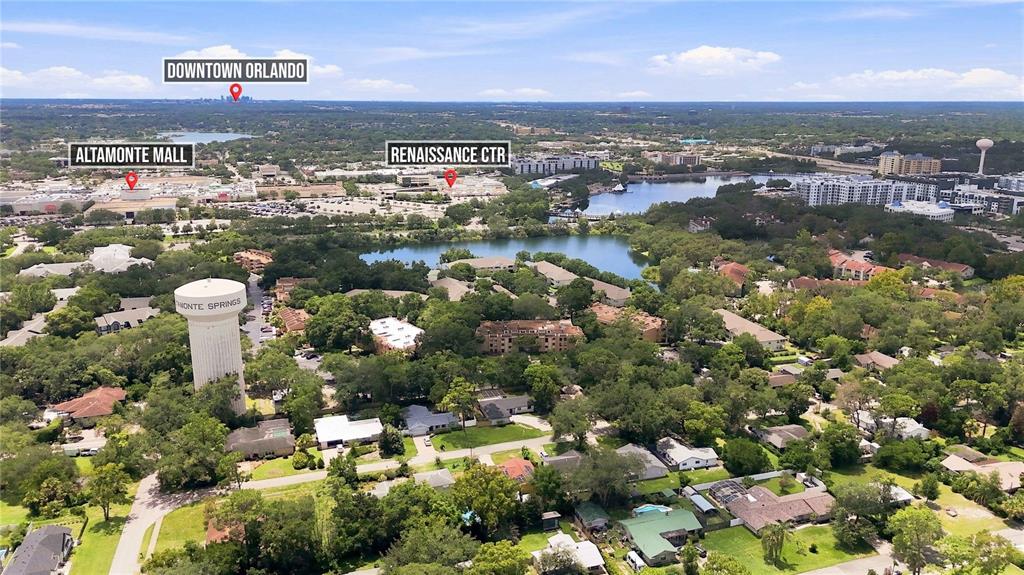 This is an aerial view of a suburban neighborhood with a water tower and mall — 620 CRANES WAY UNIT 303, ALTAMONTE SPRINGS, FL