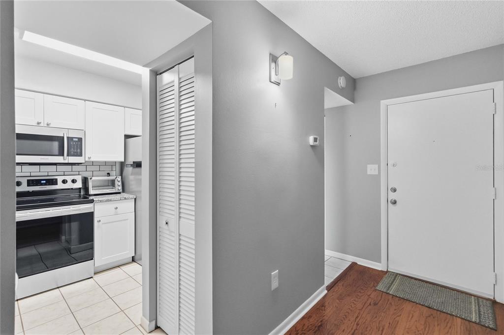 A kitchen featuring white cabinets, granite countertops, stainless steel appliances, and a double-basin sink — 620 CRANES WAY UNIT 303, ALTAMONTE SPRINGS, FL