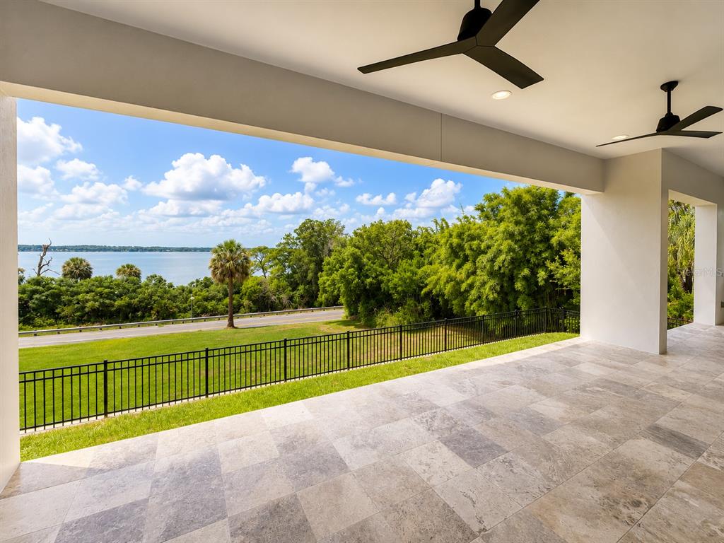 An unfinished room with a large sliding glass door opening to a waterfront view — 594 CASEY LOOP, MOUNT DORA, FL