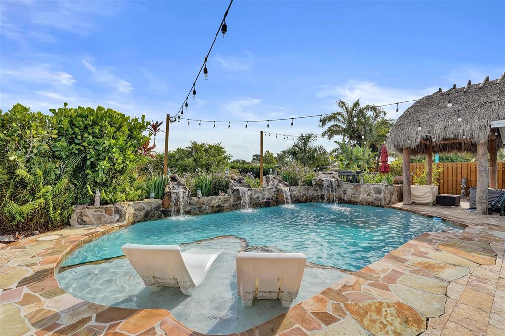 An aerial view shows a backyard with a swimming pool, tiki hut, and canal access — 12341 NW 29TH MANOR, SUNRISE, FL