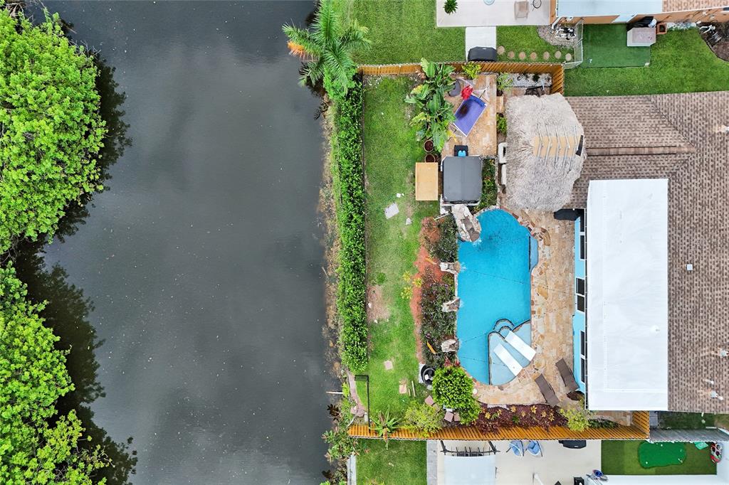 An aerial view shows a backyard with a swimming pool, hot tub, and tiki hut — 12341 NW 29TH MANOR, SUNRISE, FL