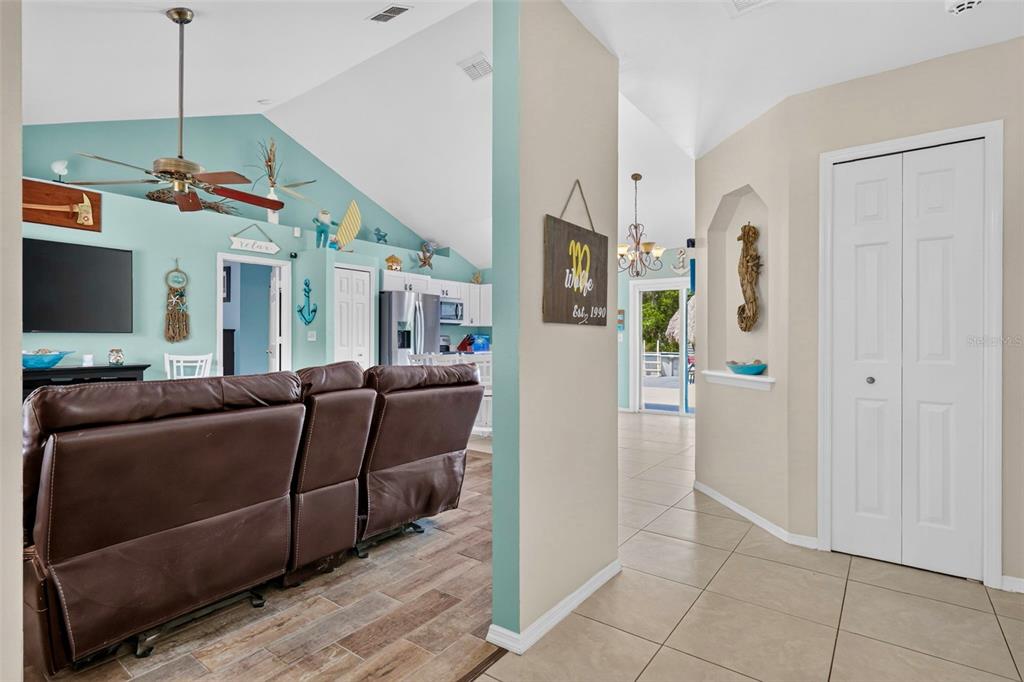 A view from a tiled hallway looking into a living room with light blue walls — 39627 GREENBRIER STREET, EUSTIS, FL