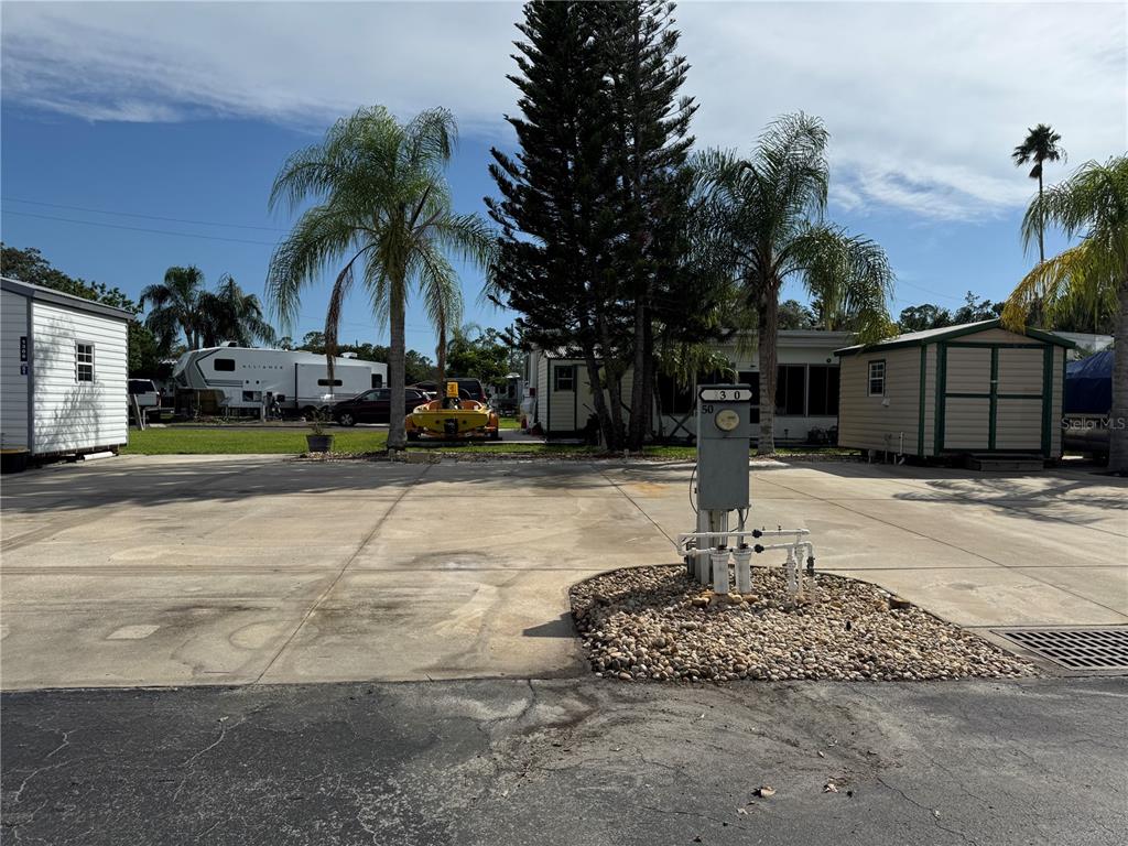 This is a satellite map view of a residential neighborhood with waterfront homes and streets — 1310 PINE ISLAND DRIVE N, ST CLOUD, FL