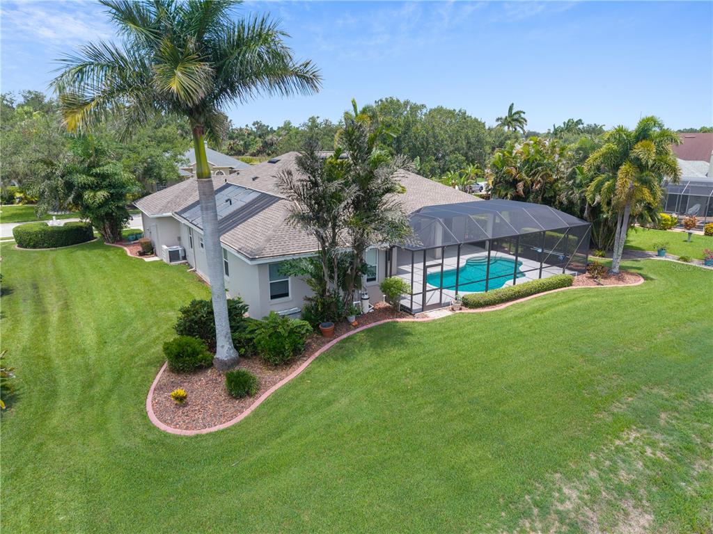 An aerial view of a house with a screened-in pool and a large grassy yard — 5375 90TH AVENUE CIRCLE E, PARRISH, FL