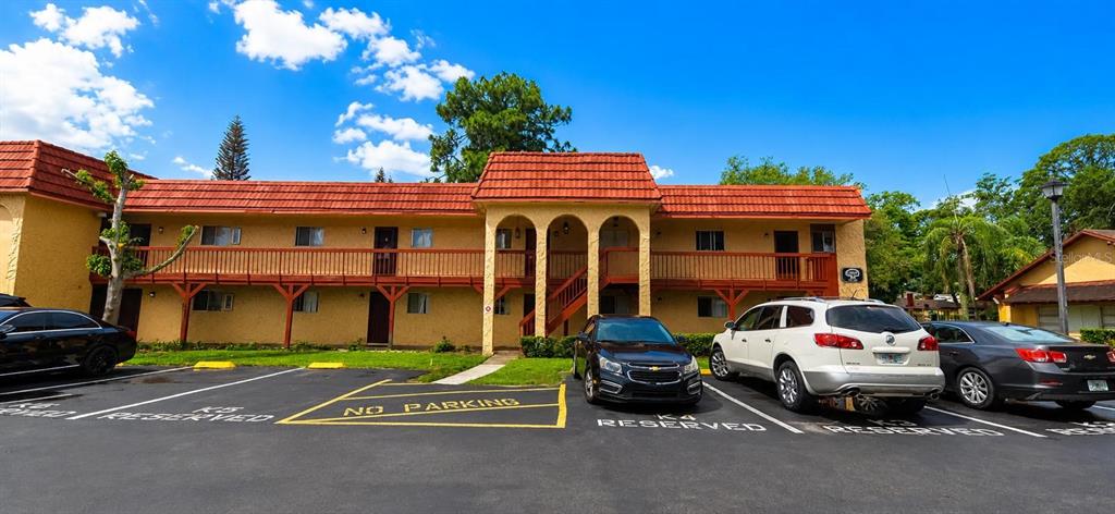 The image shows the entrance and signage for the Oak Shadows Condominiums complex — 2850 N POWERS DRIVE UNIT 83, ORLANDO, FL