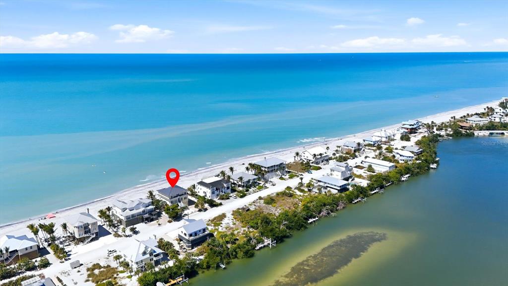 An aerial view shows a coastal house marked with a red pin on a beach — 131 S GULF BOULEVARD, PLACIDA, FL