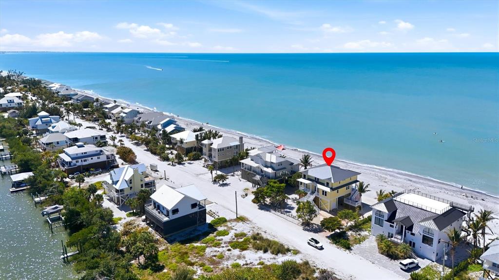 An aerial view shows a yellow beach house with a red location marker — 131 S GULF BOULEVARD, PLACIDA, FL
