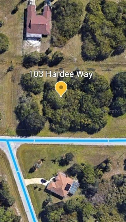 This is an aerial map view showing a wooded lot and surrounding residential properties — 103 HARDEE WAY, ROTONDA WEST, FL