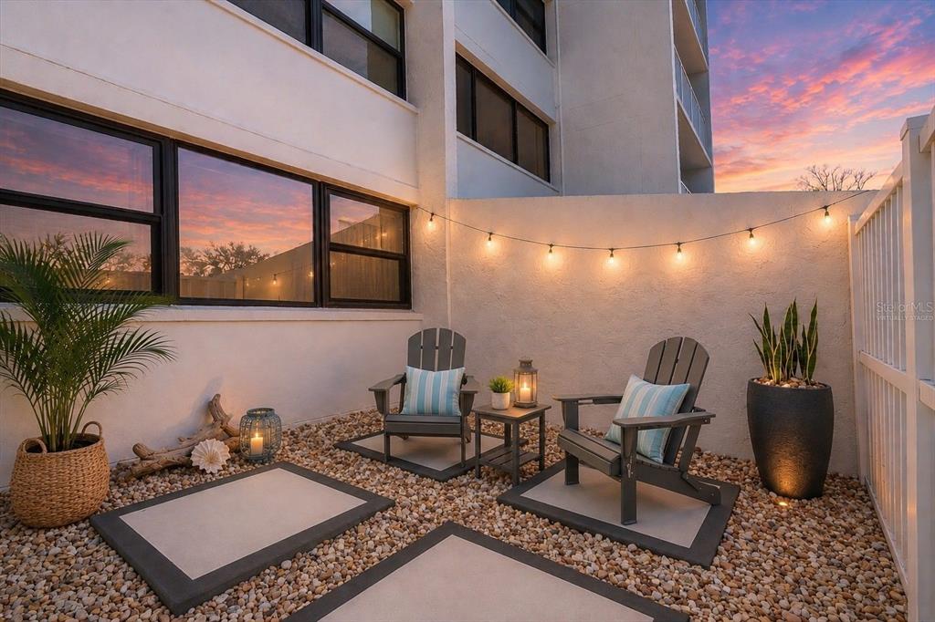 A living room features light wood furniture, a beige sofa, two armchairs, and sliding glass doors — 450 TREASURE ISLAND CAUSEWAY UNIT 102, TREASURE ISLAND, FL