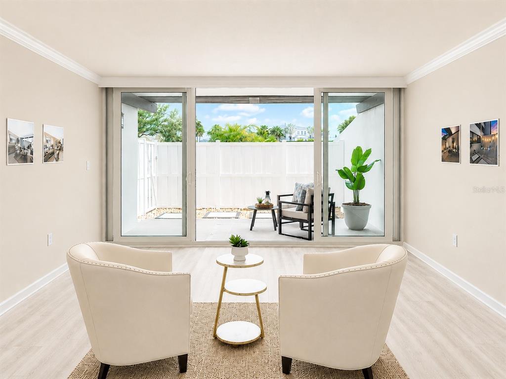 A kitchen features light wood cabinets, stone countertops, stainless steel appliances, and a tiled backsplash — 450 TREASURE ISLAND CAUSEWAY UNIT 102, TREASURE ISLAND, FL