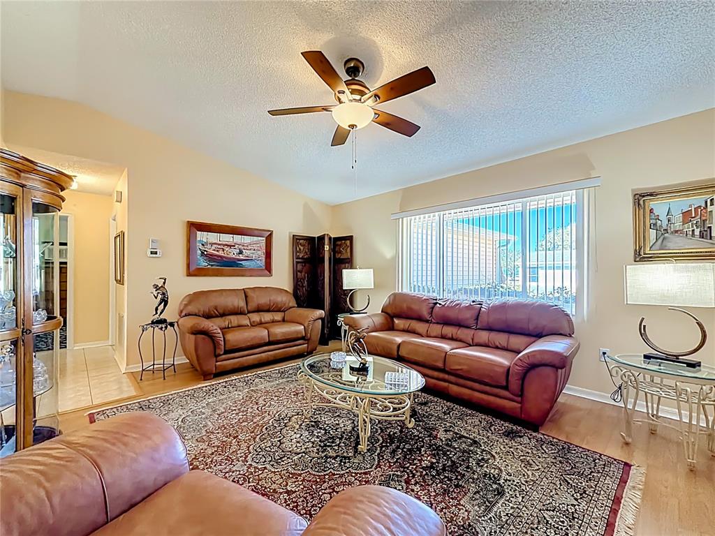 The exterior of a house features a walkway, a tiered fountain, and two cherub statues — 9826 SE 178TH LANE, SUMMERFIELD, FL