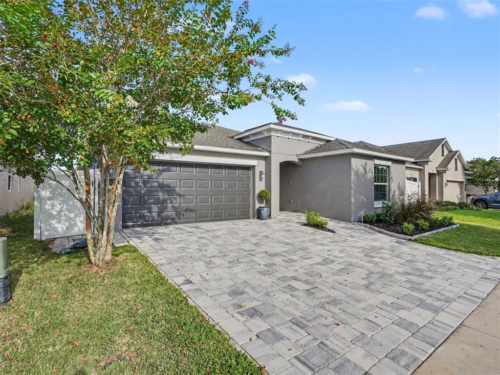 A gray single-story house with a paved driveway and a two-car garage — 149 TAFT DRIVE, DAVENPORT, FL