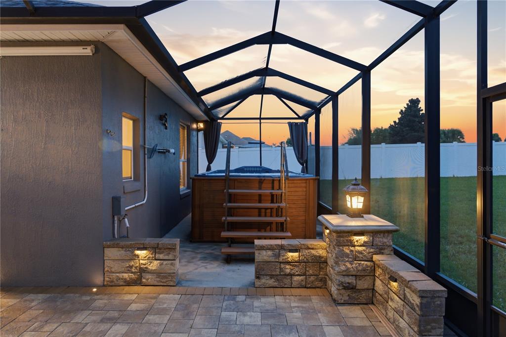 A single-story gray house with a three-car garage and a manicured lawn — 230 LAKE ARIETTA COURT, AUBURNDALE, FL