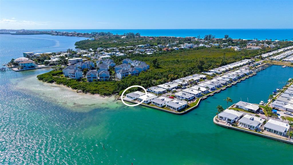 An aerial view shows a waterfront residential complex with a circled house on the point — 948 SPANISH DRIVE S, LONGBOAT KEY, FL