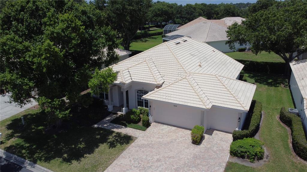 An aerial view of a single-story house with a light-colored tile roof and driveway — 3916 SCARBOROUGH COURT, CLERMONT, FL