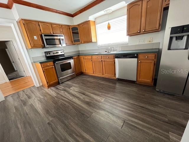 A kitchen features wood cabinets, stainless steel appliances, and wood-look flooring — 2506 W UNION STREET, TAMPA, FL