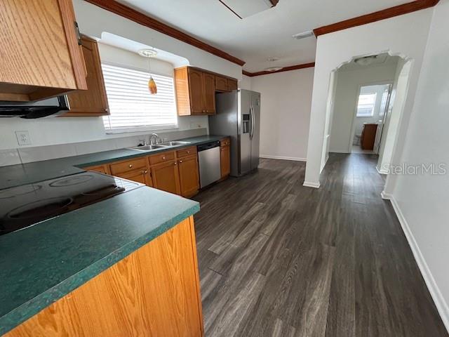 A kitchen features wood cabinets, dark countertops, stainless steel appliances, and wood-look flooring — 2506 W UNION STREET, TAMPA, FL