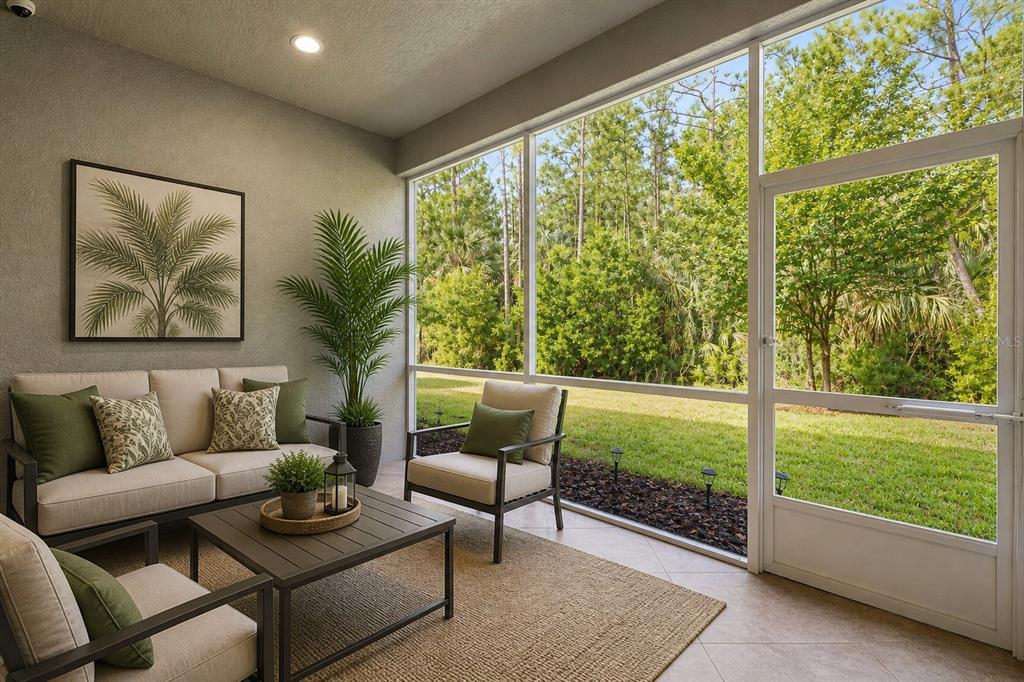 A screened-in patio features outdoor furniture, a rug, and a view of a wooded backyard — 829 PINEWOOD DRIVE, ORMOND BEACH, FL