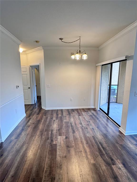 An empty room with light-colored walls, wood-look flooring, a ceiling fan, and a window — 2249 PORTOFINO PLACE UNIT 22-2217, PALM HARBOR, FL