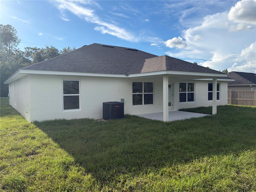An unfinished interior room features vaulted ceilings and walls covered in newly installed drywall — 15691 SE 97TH AVENUE, SUMMERFIELD, FL