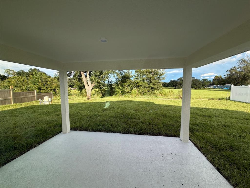 A view from an entryway into a living area with light-colored tile flooring — 15691 SE 97TH AVENUE, SUMMERFIELD, FL