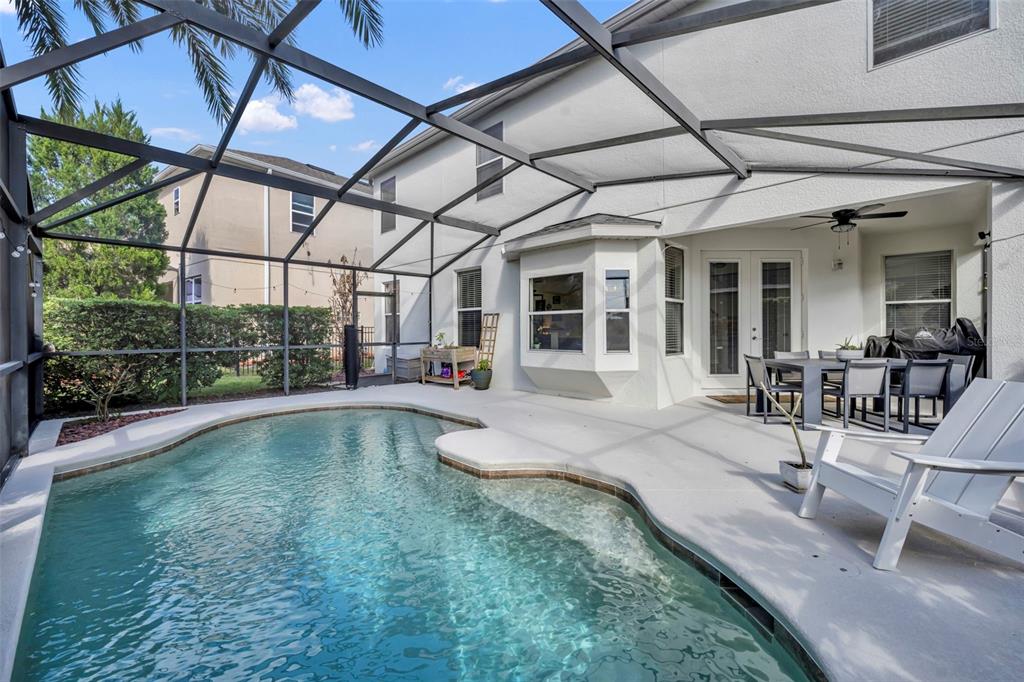 A two-story house with a white stucco exterior, a two-car garage, and a blue door — 2329 NATOMA BLVD, MOUNT DORA, FL