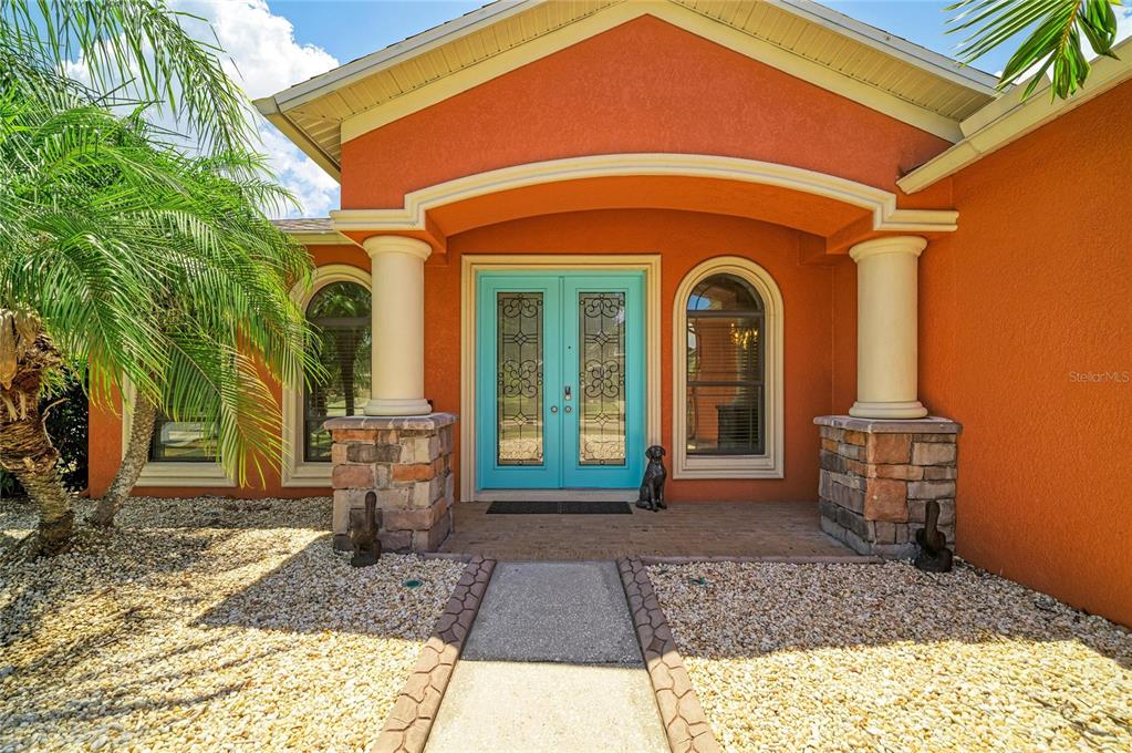 The exterior of a house features a bright blue double door under a covered entryway — 316 STAR SHELL DRIVE, APOLLO BEACH, FL