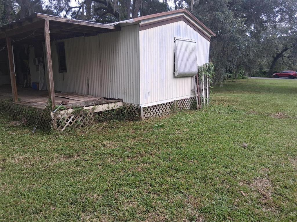 A room with light-colored tile flooring, a purple door, and a window with white blinds — 19399 FORT DADE AVENUE, BROOKSVILLE, FL