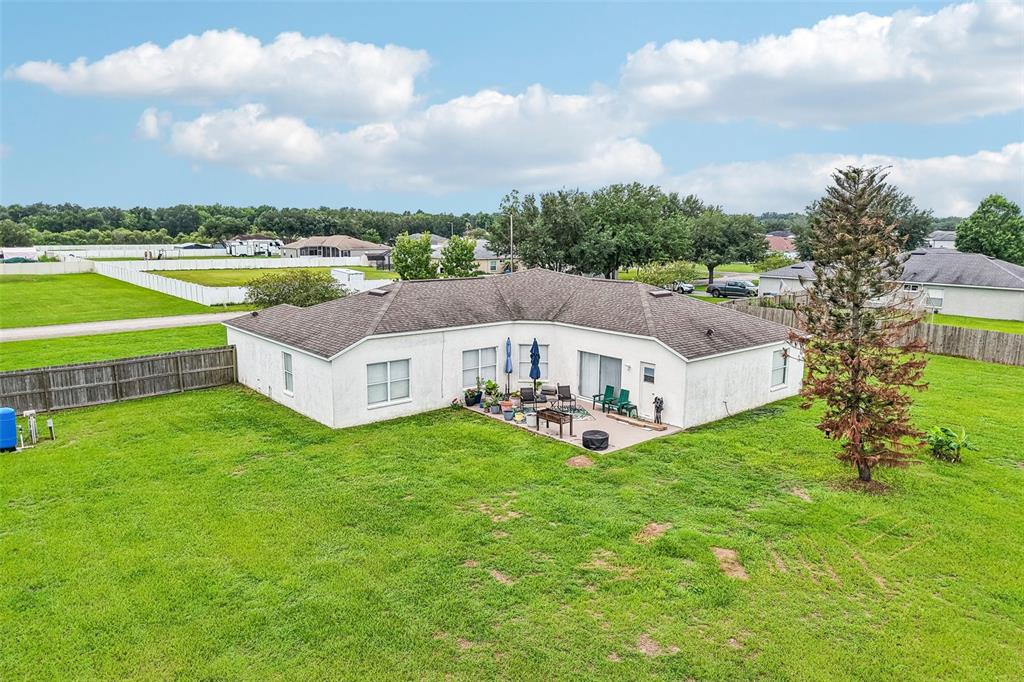 A room with wood-look flooring, a white rocking chair, and an upright piano — 2206 WOODEN SHOE WAY, PLANT CITY, FL