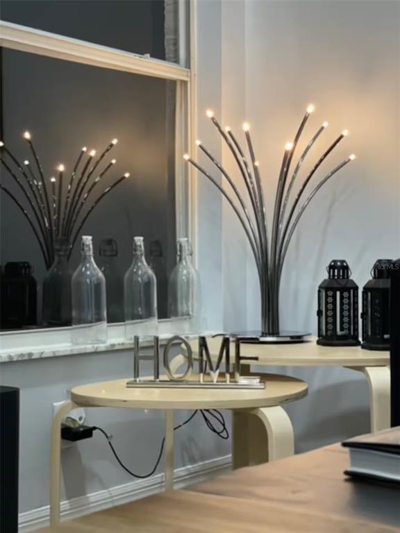 A modern table lamp with fiber-optic style lights sits on a small table near a window — 102 W FREDERICK AVENUE, LAKE MARY, FL
