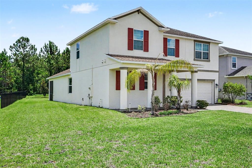 A bedroom with beige carpet, light gray walls, a closet, and a doorway to another room — 490 BRUNSWICK DRIVE, DAVENPORT, FL