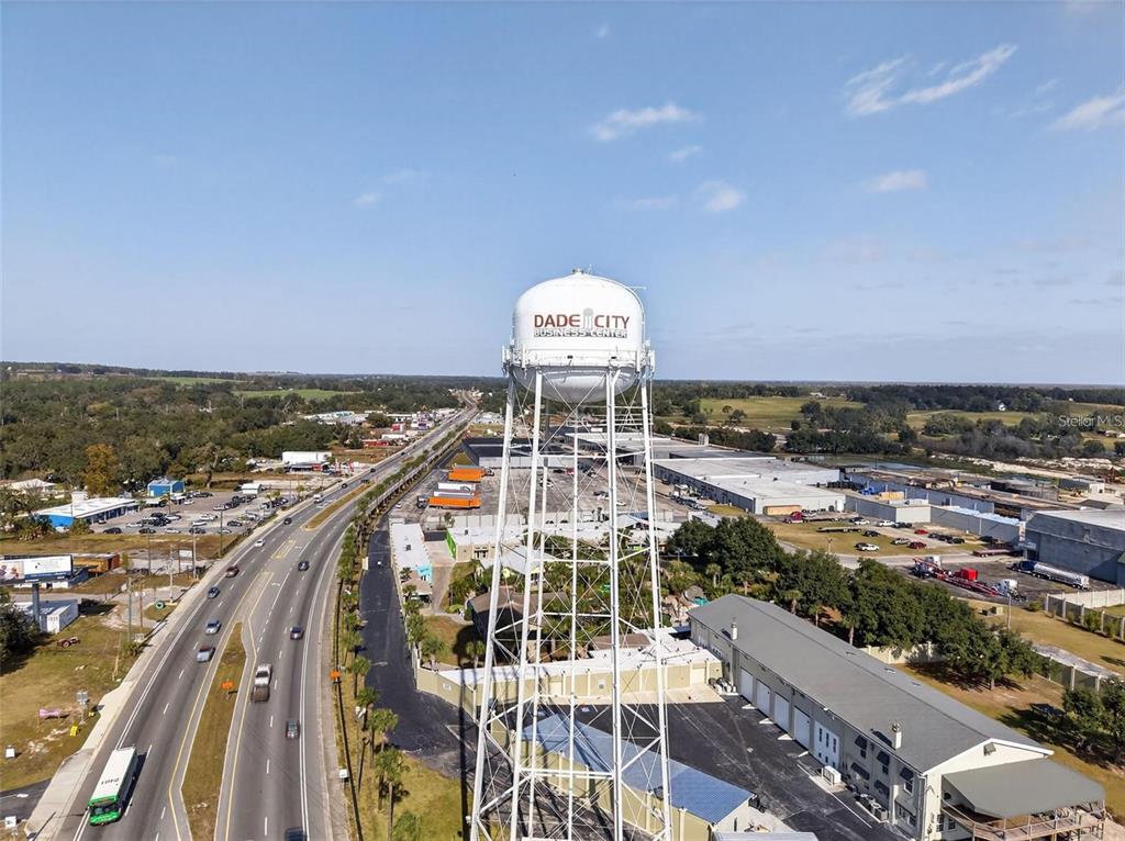 An aerial view shows a large water tower labeled Dade City Business Center near a highway — 36893 HIDDEN VIEW CIRCLE, DADE CITY, FL