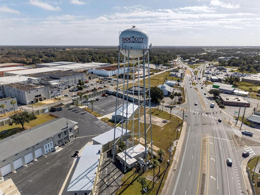 An aerial view shows a large water tower labeled Dade City Business Center near roads — 36893 HIDDEN VIEW CIRCLE, DADE CITY, FL