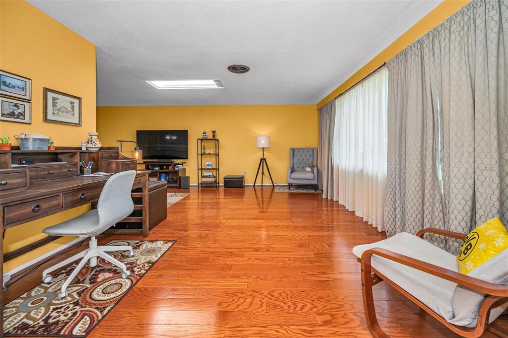 A single-story house with a white garage and large trees in the front yard — 1368 WILLIAMS DRIVE, CLEARWATER, FL